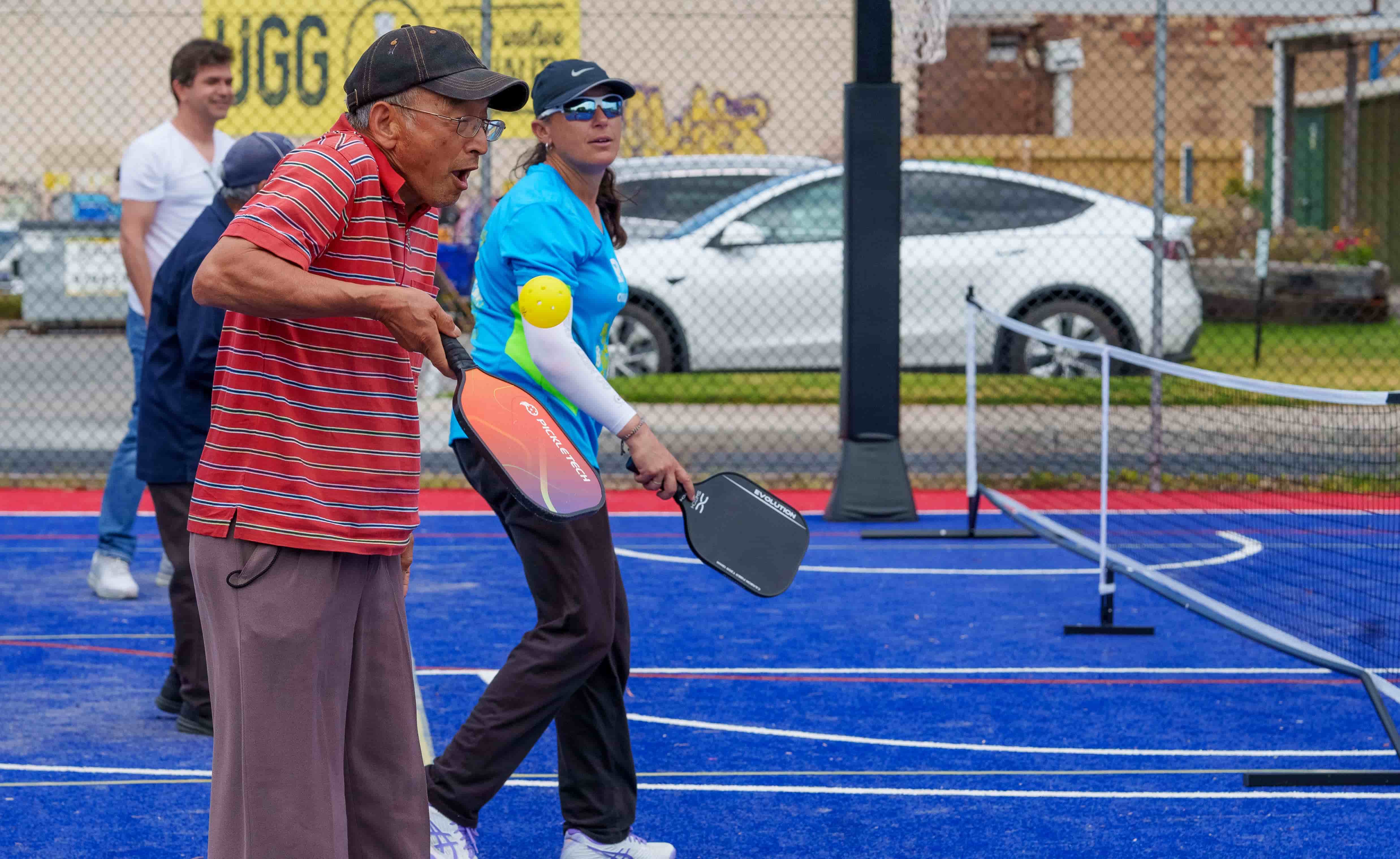 Two people playing pickle ball