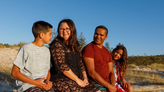 Aboriginal family sitting at the beach