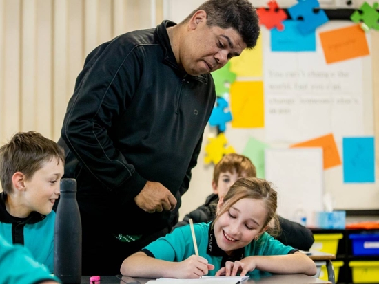A teacher looking over a student's work