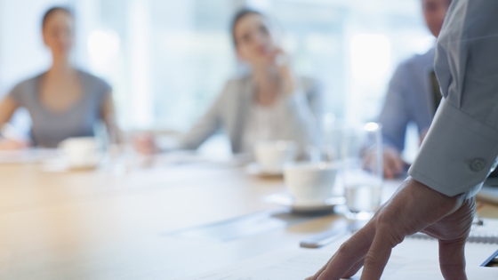 unfocussed image of men and women in a meeting