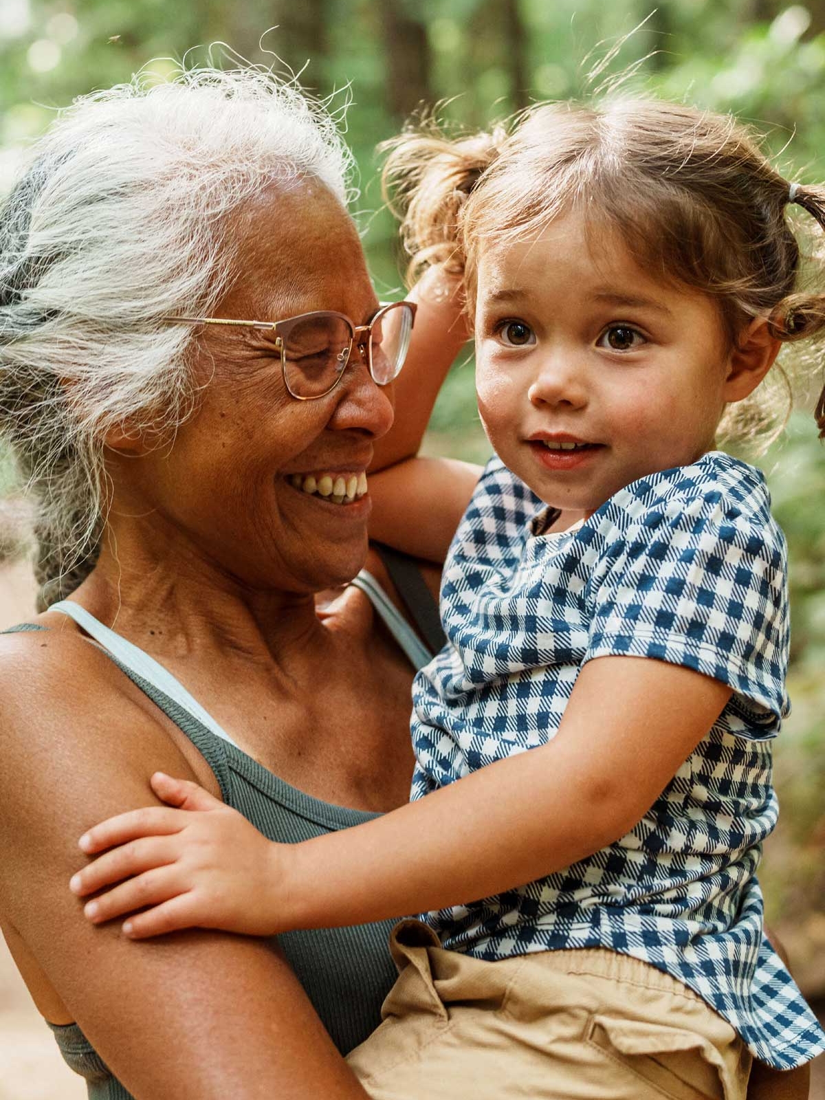 Smiling grandmother holding her granddaughter