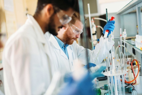 Group of researchers with test tubes in a lab environment