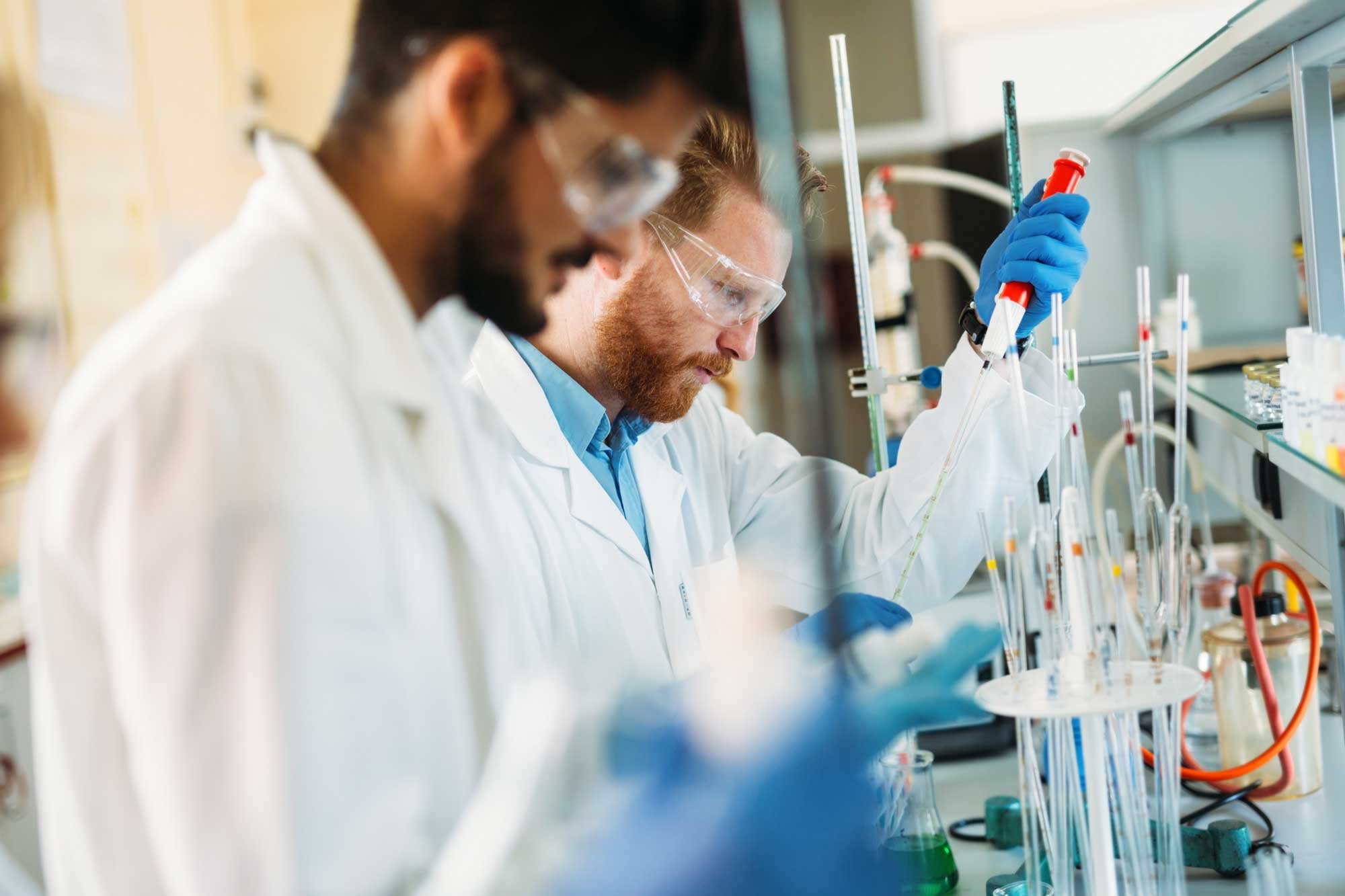 Group of researchers with test tubes in a lab environment