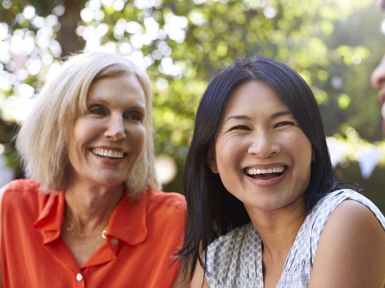 Group of women smiling (mixed backgrounds)